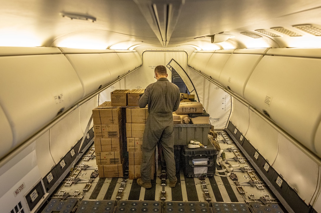 U.S. Marine Corps Tate Smith, aircraft loadmaster, assigned to Marine Transport Squadron (VMR) 1, Marine Air Group 41, 4th Marine Air Wing, secures cargo during ARCTIC EDGE 2025 (AE25) at Joint Base Elmendorf-Richardson, Alaska, Aug. 21, 2025. Specialized Arctic training generates valuable lessons learned for warfighters and enablers ensuring they can execute their assigned missions in any environment. AE25 is a NORAD and U.S. Northern Command-led homeland defense exercise designed to improve readiness, demonstrate capabilities and enhance Joint and Allied Force interoperability in the Arctic. (U.S. Marine Corps Photo by Lance Cpl. Edward Spears)