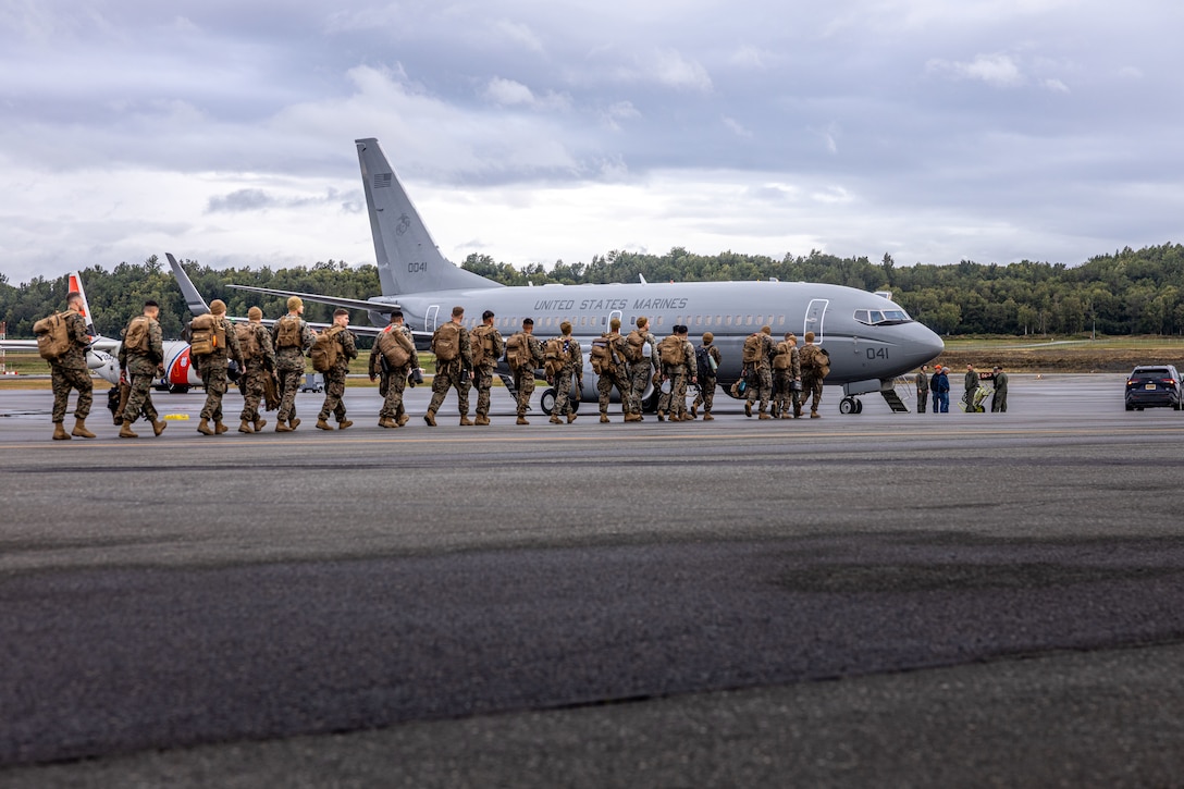 U.S. Marines walk toward a C-40A aircraft, assigned to Marine Transport Squadron (VMR) 1, Marine Air Group 41, 4th Marine Air Wing, during ARCTIC EDGE 2025 (AE25) at Joint Base Elmendorf-Richardson, Alaska, Aug. 21, 2025. Specialized Arctic training generates valuable lessons learned for warfighters and enablers ensuring they can execute their assigned missions in any environment. AE25 is a NORAD and U.S. Northern Command-led homeland defense exercise designed to improve readiness, demonstrate capabilities and enhance Joint and Allied Force interoperability in the Arctic. (U.S. Marine Corps Photo by Lance Cpl. Edward Spears)