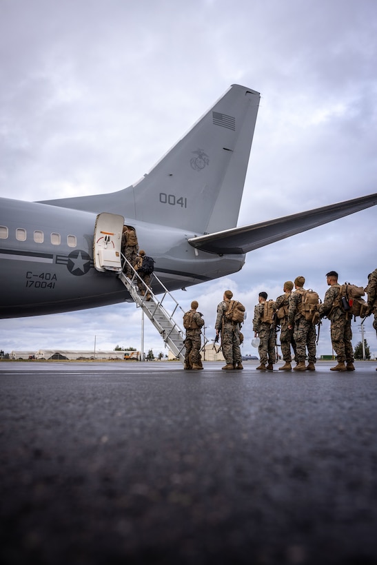 U.S. Marines load onto a C-40A aircraft, assigned to Marine Transport Squadron (VMR) 1, Marine Air Group 41, 4th Marine Air Wing, during ARCTIC EDGE 2025 (AE25) at Joint Base Elmendorf-Richardson, Alaska, Aug. 21, 2025. Specialized Arctic training generates valuable lessons learned for warfighters and enablers ensuring they can execute their assigned missions in any environment. AE25 is a NORAD and U.S. Northern Command-led homeland defense exercise designed to improve readiness, demonstrate capabilities and enhance Joint and Allied Force interoperability in the Arctic. (U.S. Marine Corps Photo by Lance Cpl. Edward Spears)