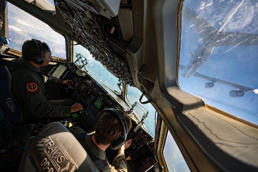 Airmen pilot a C-17 while a KC-46 prepares to refuel