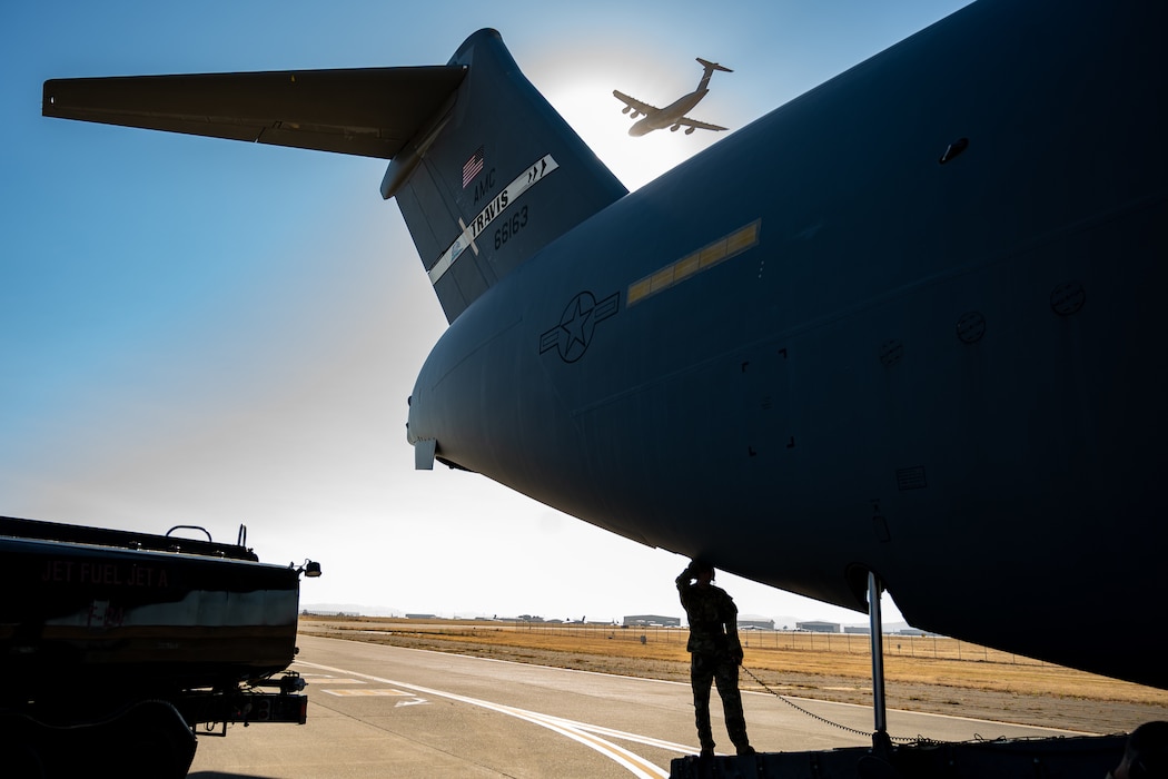 An Airman stands at the open back door of a C-17