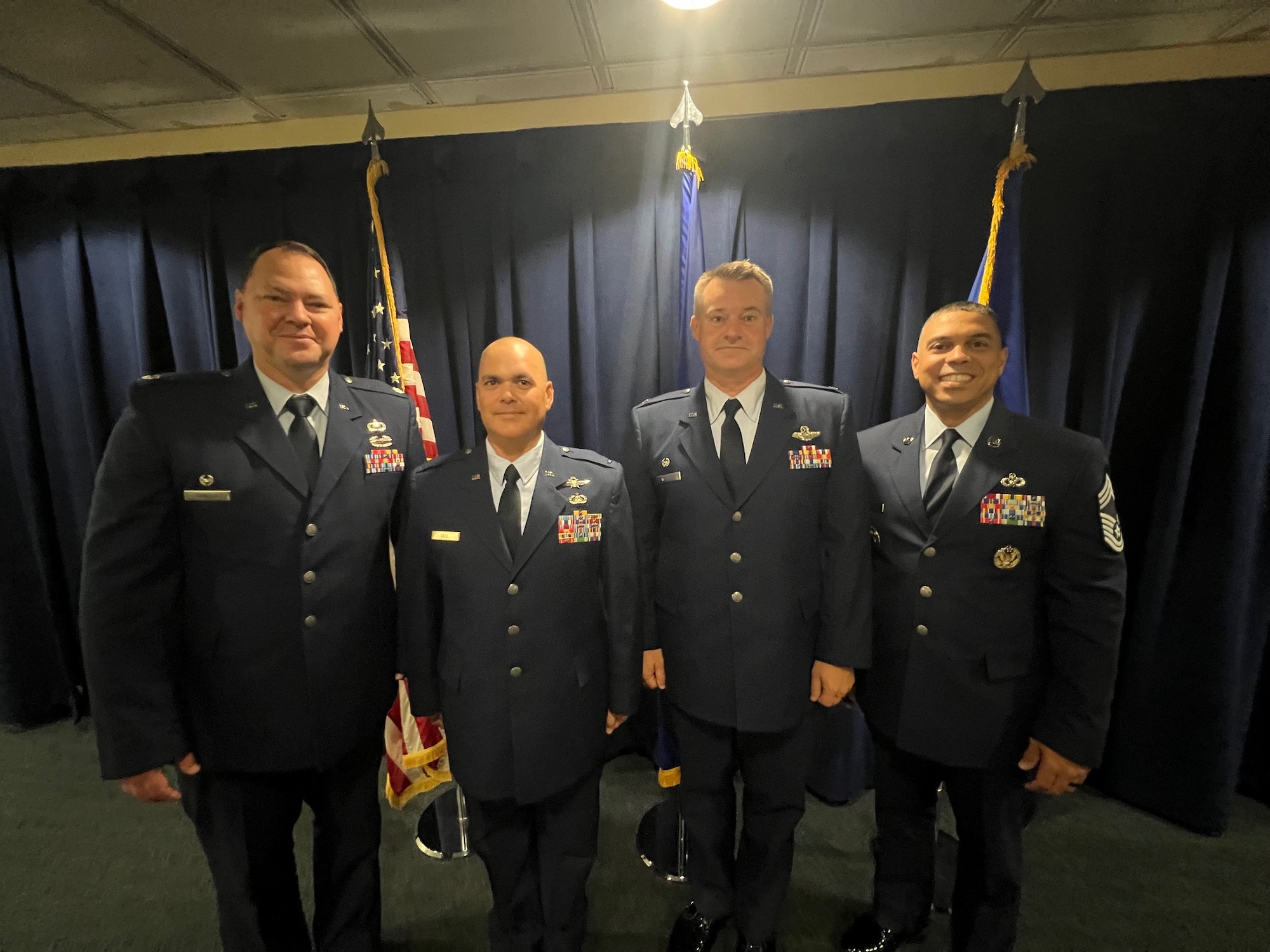 Four USAF members wearing blues stand together