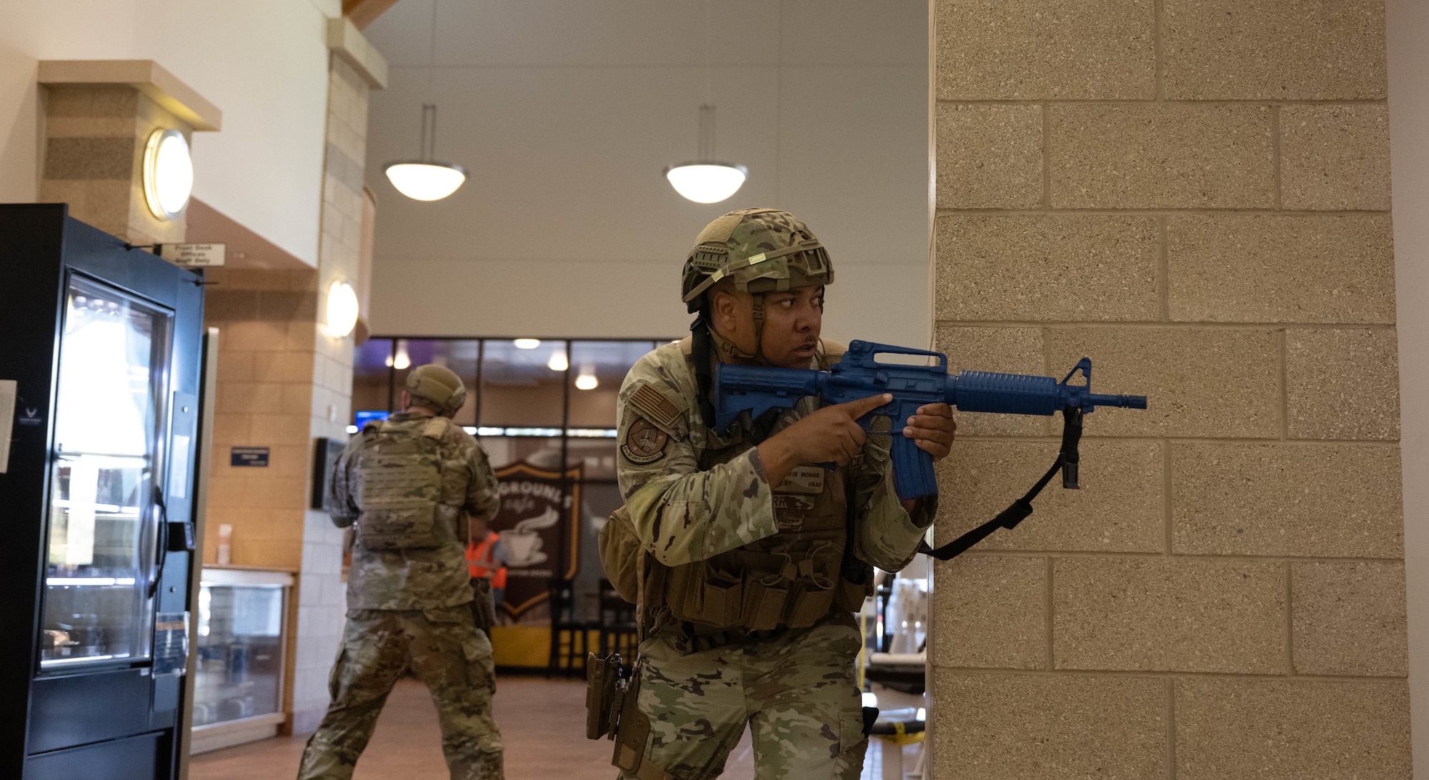 U.S. Air Force Master Sgt. Alvin Morris, 47th Security Forces Squadron anti-terrorism and mission assurance manager, looks down a hallway during an active shooter exercise at Lossano Fitness Center, Sept. 4, 2025.  47th SFS members participated in the exercise to practice tactics during high-risk scenarios.  (U.S. Air Force photo by Airman 1st Class Darryl Keith.)