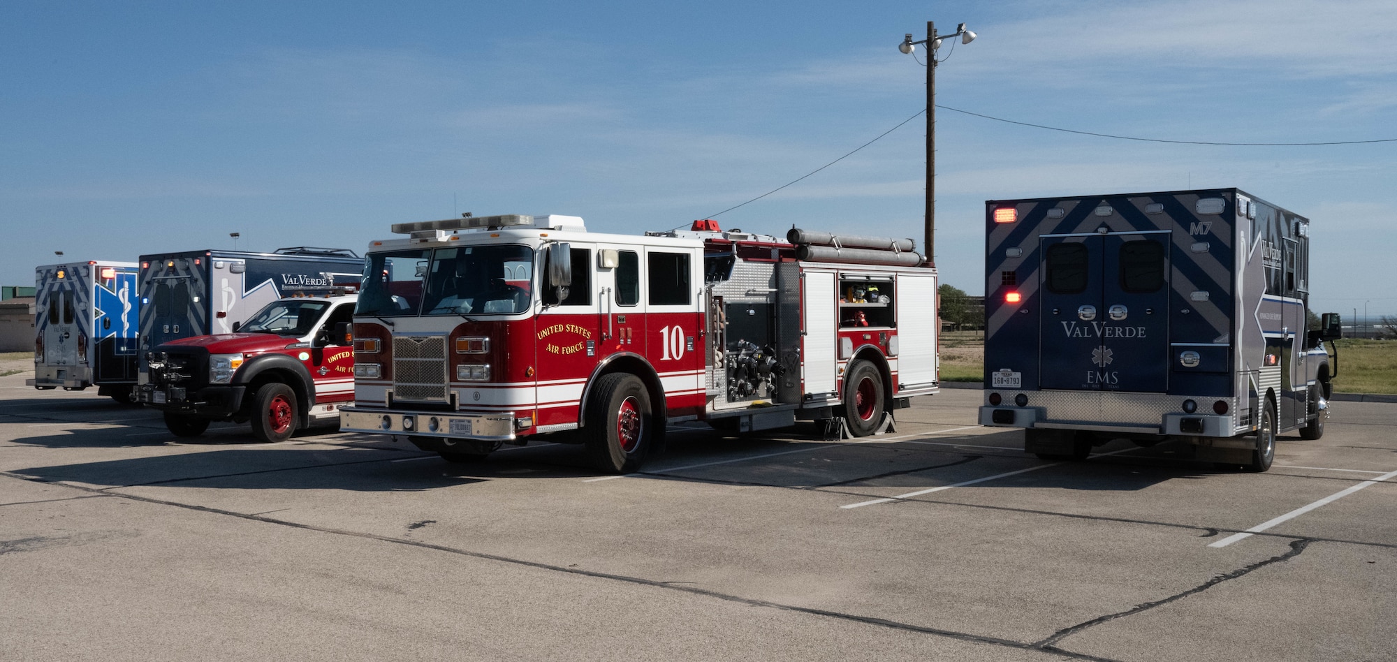 Val Verde Regional Medical Center ambulances and 47th Civil Engineering Squadron fire trucks park near Lossano Fitness Center, Sept. 4, 2025.  The 47th Flying Training Wing worked alongside local emergency services and law enforcement for a base wide active shooter exercise. (U.S. Air Force photo by Airman 1st Class Darryl Keith.)