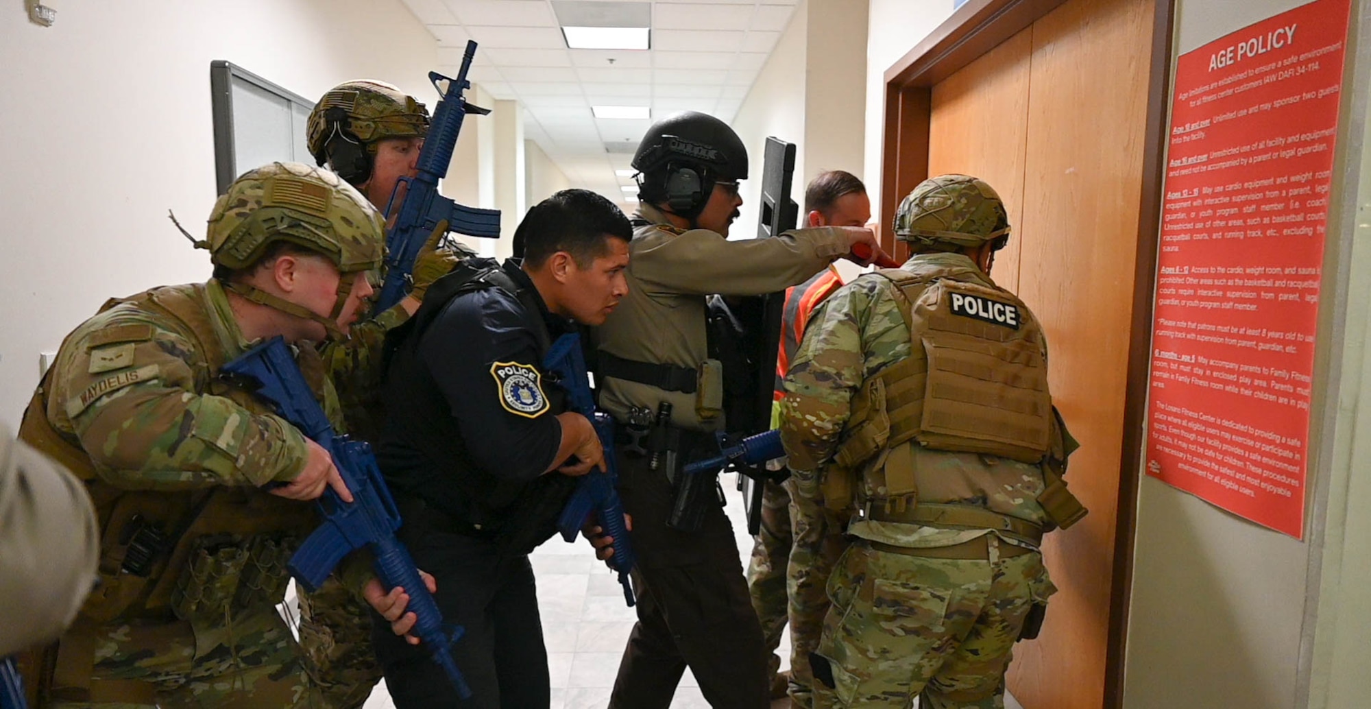 Members of the 47th Security Forces Squadron and Val Verde County Sherrif's Office prepare to breach a room during an active shooter exercise at Losano Fitness Center, Sept. 4, 2025.  The exercise aided law enforcement in handling hostage situation during high-risk situations. (U.S. Air Force photo by Airman 1st Class Darryl Keith.)