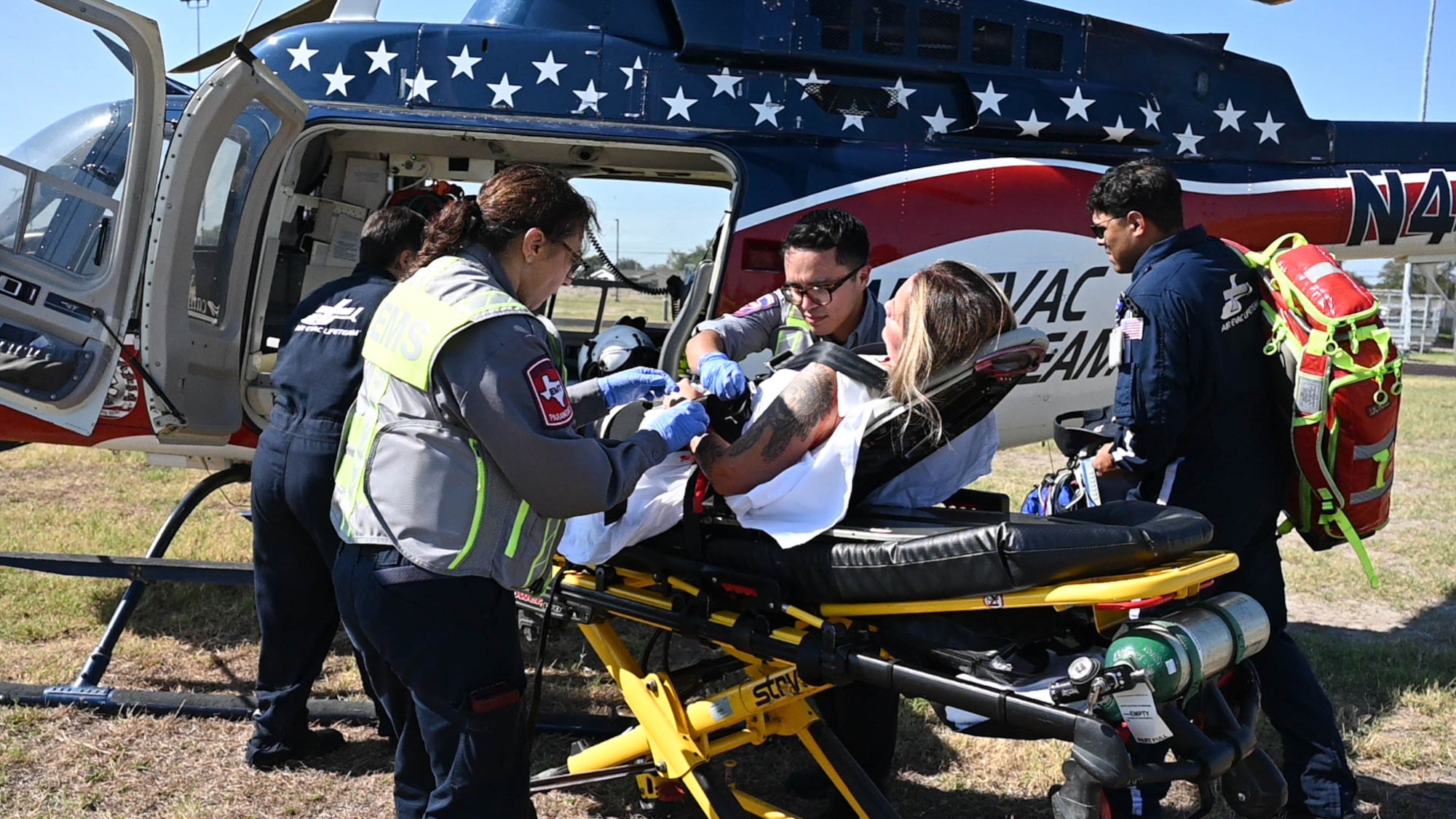 Val Verde Regional Medical Center air medical evacuation personnel provide aid to a injured person during an active shooter exercise at Laughlin Air Force Base, Texas, Sept. 4, 2025.  The base exercise served as the first time local air medical evacuation was involved. (U.S Air Force photo by Airman 1st Class Darryl Keith.)