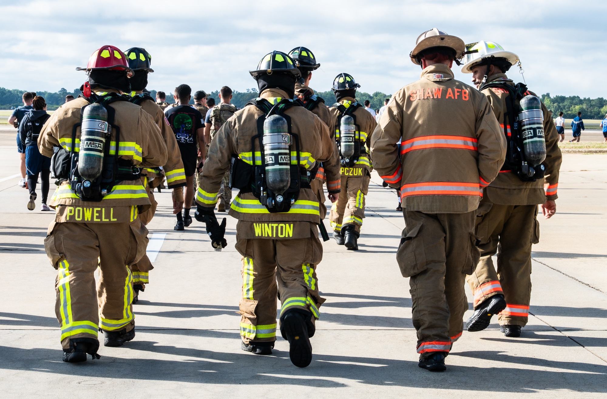 A group of firefighters walk in a line during a 9/11 memorial 5k.