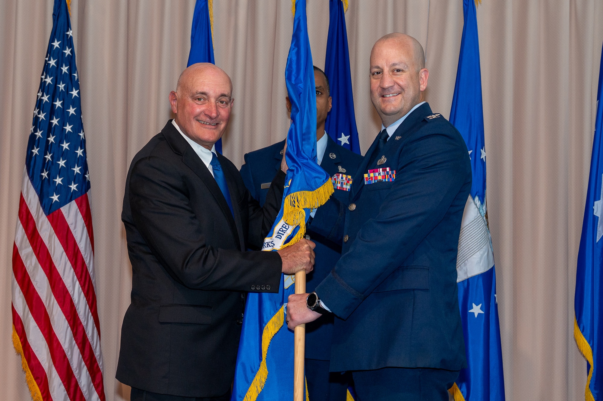 Image of two people holding a flag.