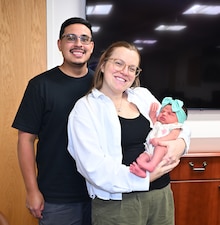 Naval Hospital Jacksonville Labor and Delivery Nurse Lt. Danielle Acosta, husband Daniel Acosta, and baby Dahlia, pose for a photo. Acosta was born at Naval Hospital Jacksonville in 1998 to a mother who was also a U.S. Navy Labor and Delivery nurse.