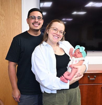 Naval Hospital Jacksonville Labor and Delivery Nurse Lt. Danielle Acosta, husband Daniel Acosta, and baby Dahlia, pose for a photo. Acosta was born at Naval Hospital Jacksonville in 1998 to a mother who was also a U.S. Navy Labor and Delivery nurse.