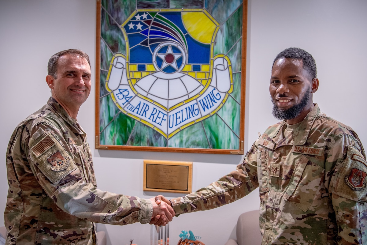 Col. Michael S. Albert, 434th Air Refueling Wing commander, Grissom Air Reserve Base, Indiana, coins Tech. Sgt. Abdoulie Bah, Team Grissom recruiter, 350th Recruiting Squadron, for breaking a recruiting record by reaching 100 accessions within the 2025 fiscal year, becoming a ’Centurian Club’ recruiter August 9, 2025. The last time a recruiter accessed 100 or more new Airmen was in 2014 and there have been fewer than 10 to earn the distinction within the past 20 years. (U.S. Air Force photo by Master Sgt. Benjamin Mota)