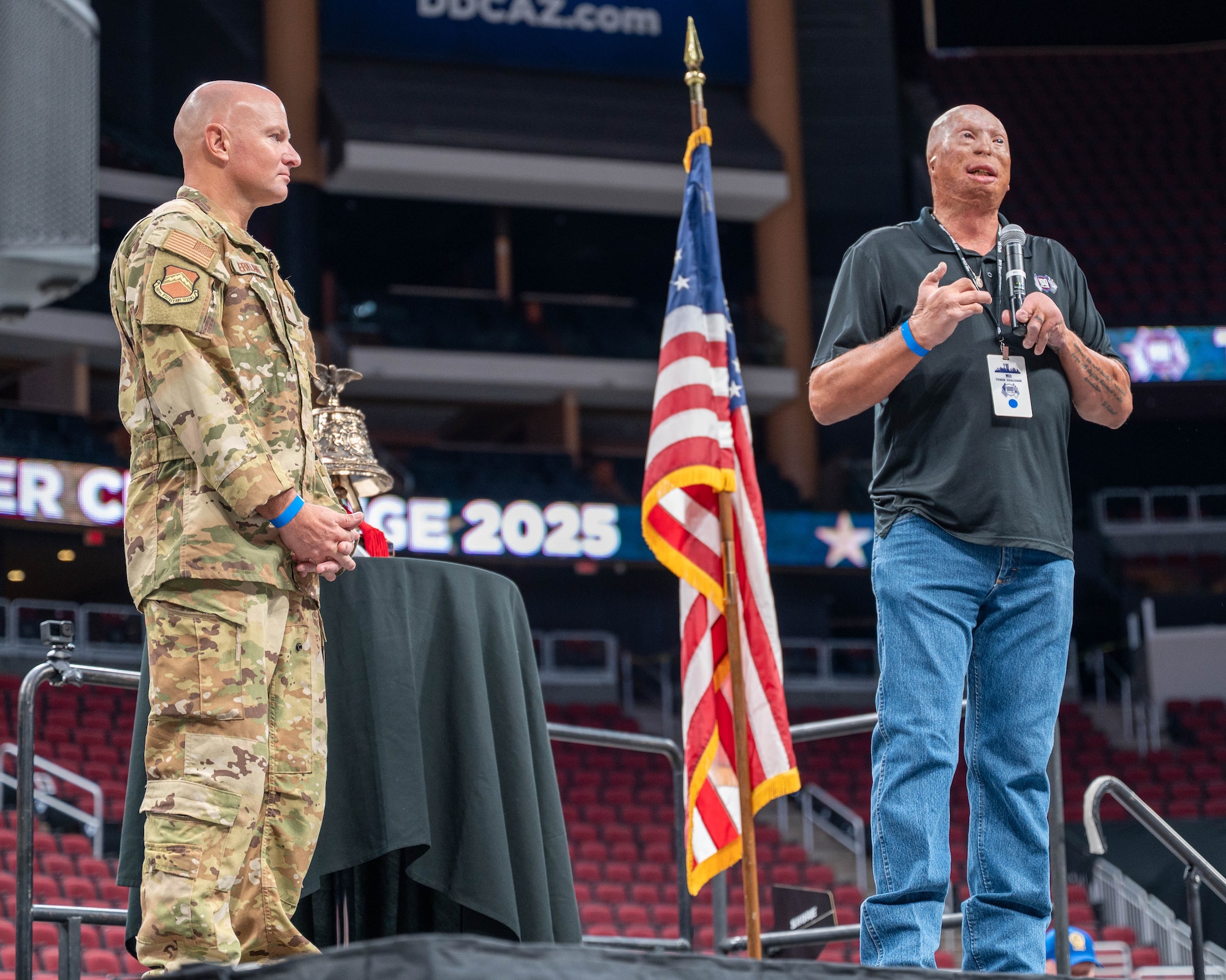 U.S. Air Force Brig. Gen. David Berkland (left), 56th Fighter Wing commander, and Jason Schechterle (right), 100 Club of Arizona community relations director, speak to a crowd at the 2025 Tower Challenge at Desert Diamond Arena, Glendale, Arizona, Sept. 6, 2025.