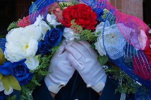 A base honor guardsman assigned to the 509th Force Support Squadron holds a wreath during a 9/11 remembrance ceremony at Whiteman Air Force Base, Missouri, Sept. 11, 2025. The wreath was laid in memory of those who lost their lives during the attack on Sept. 11, 2001. (U.S. Air Force photo by Senior Airman Joseph Garcia)