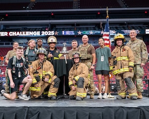 Luke Air Force Base leadership and members of the Luke Fire Department stand around a bell upon completion of the 2025 Tower Challenge at Desert Diamond Arena, Glendale, Arizona, Sept. 6, 2025.