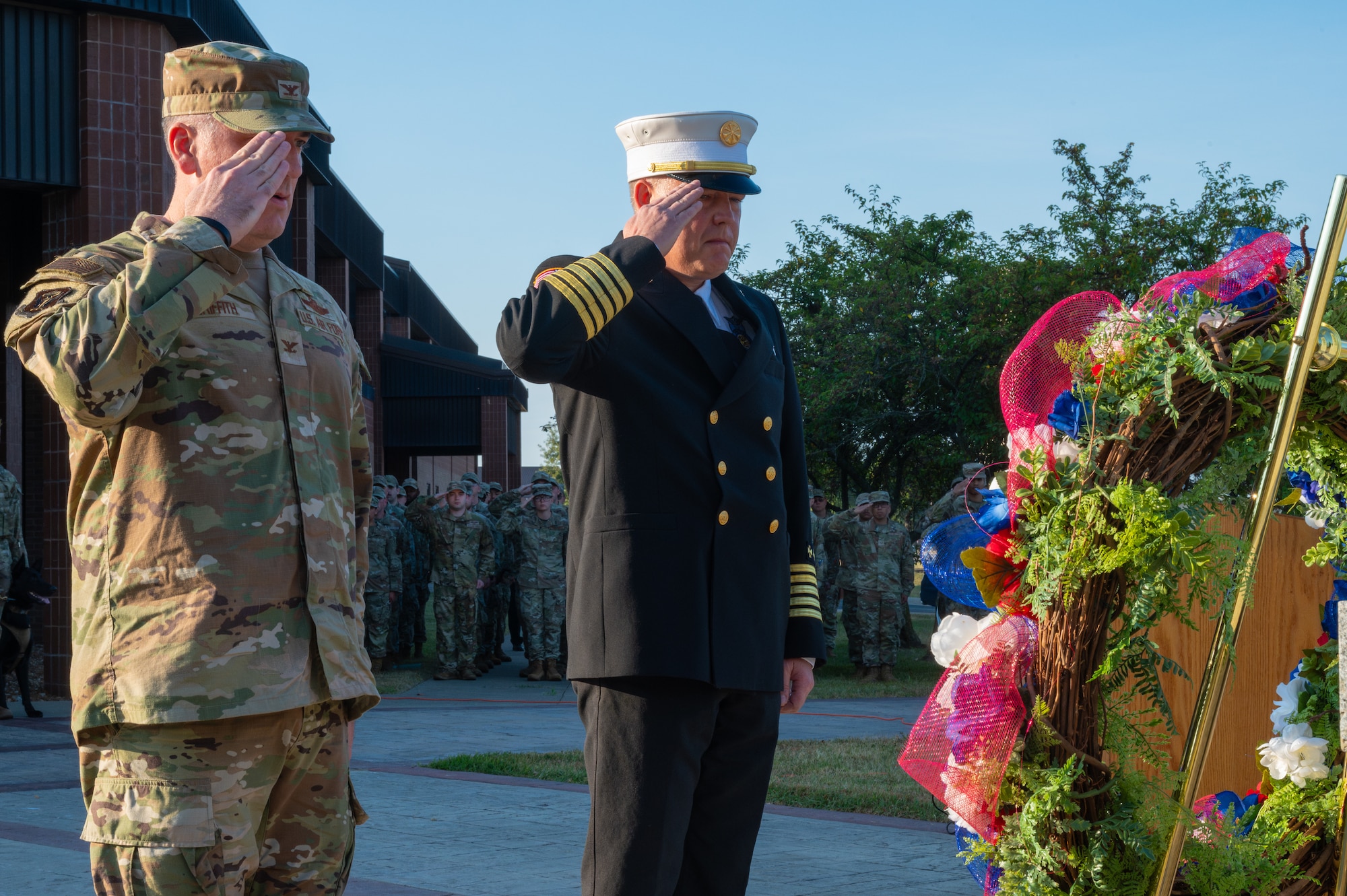 U.S. Air Force Col. Timothy Griffith, 509th Bomb Wing deputy commander, left, and William O’Meara, 509th Civil Engineering fire chief, salute a wreath during a 9/11 remembrance ceremony at Whiteman Air Force Base, Missouri, Sept. 11, 2025. The wreath was laid in memory of those who lost their lives during the attack on Sept. 11, 2001. (U.S. Air Force photo by Senior Airman Joseph Garcia)