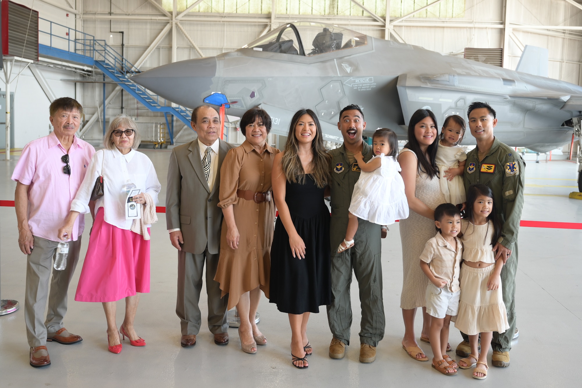 A photo of airmen and civilians posing.