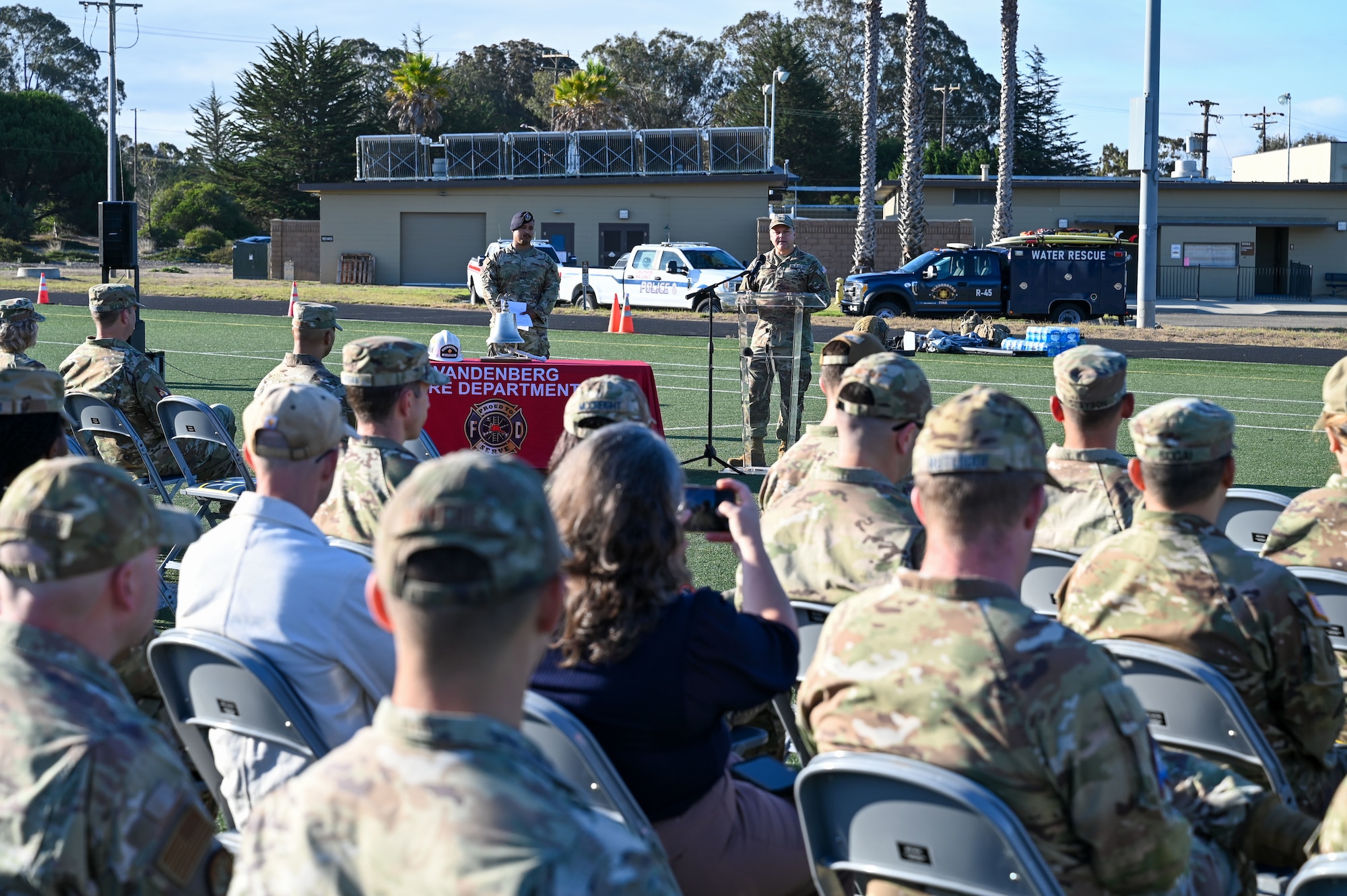 a man stands at a podium and talks to a crowd