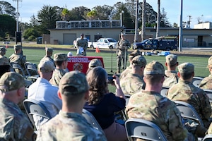 a man stands at a podium and talks to a crowd