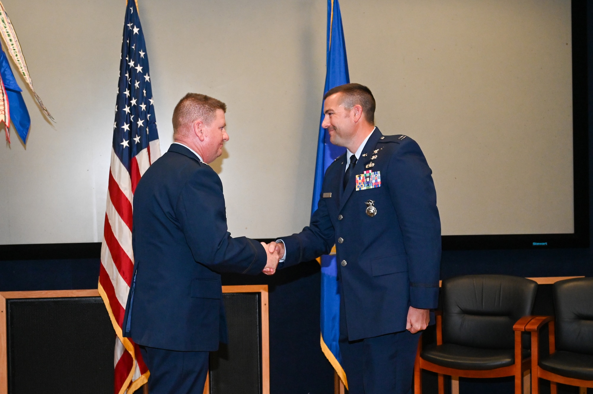 Col. Jeremy Patrick, 433rd Mission Support Group commander, shakes hands with Capt. Scott Bean, 433rd SFS commander, during an assumption of command ceremony at Joint Base San Antonio-Lackland, Texas, Sept. 6, 2025.