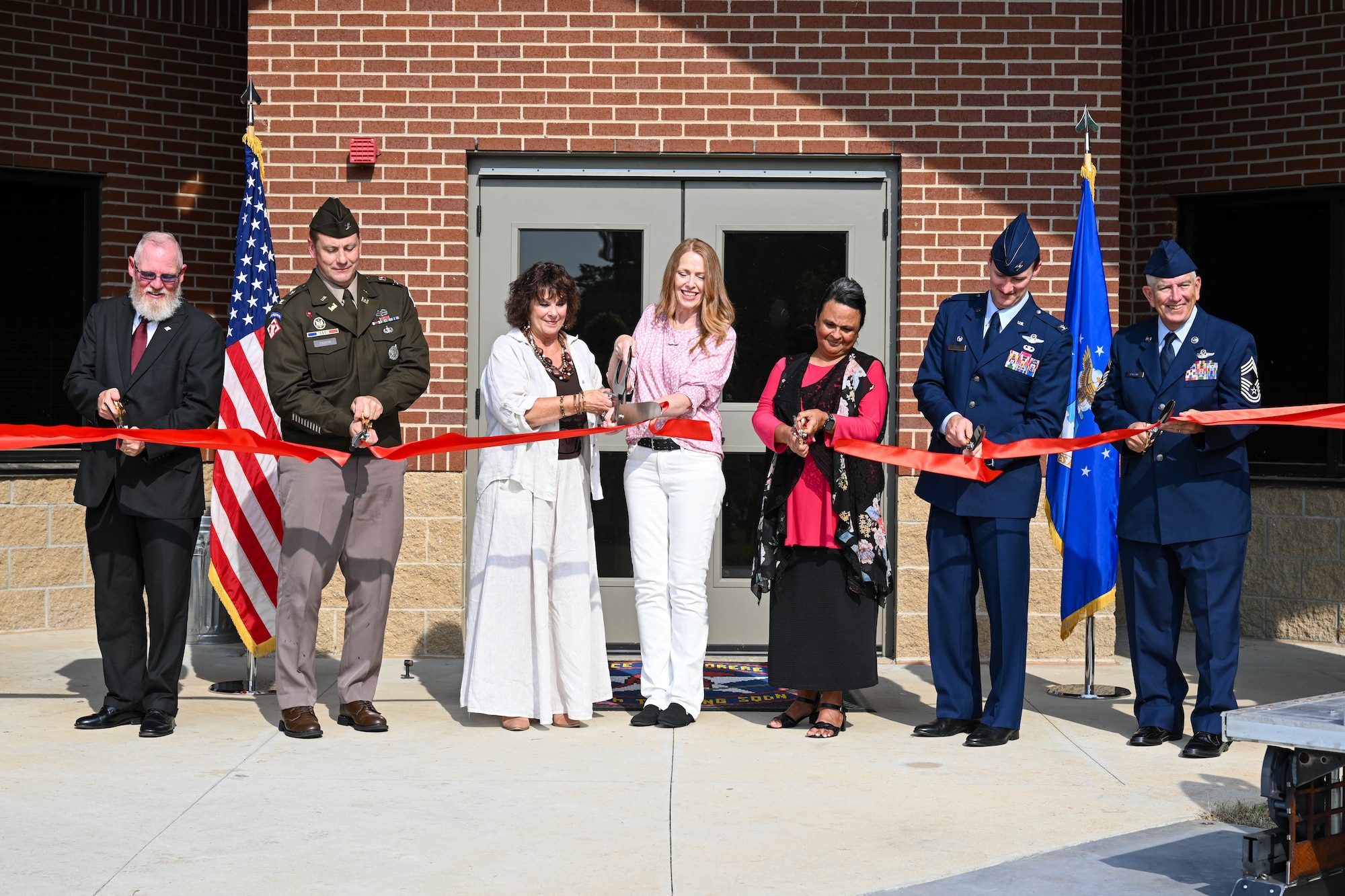 People cut a ribbon