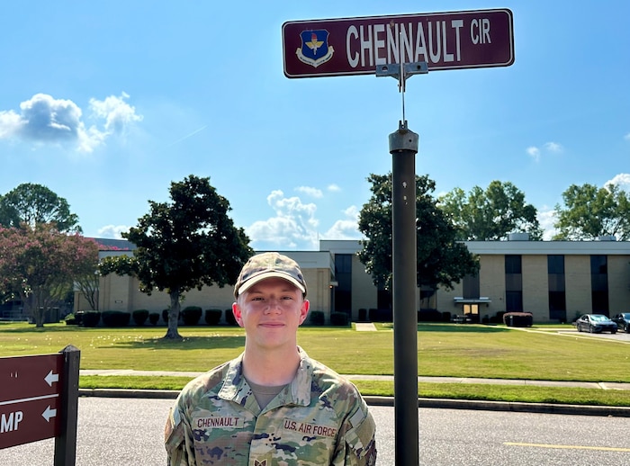 Chennault poses next to a sign with his name.