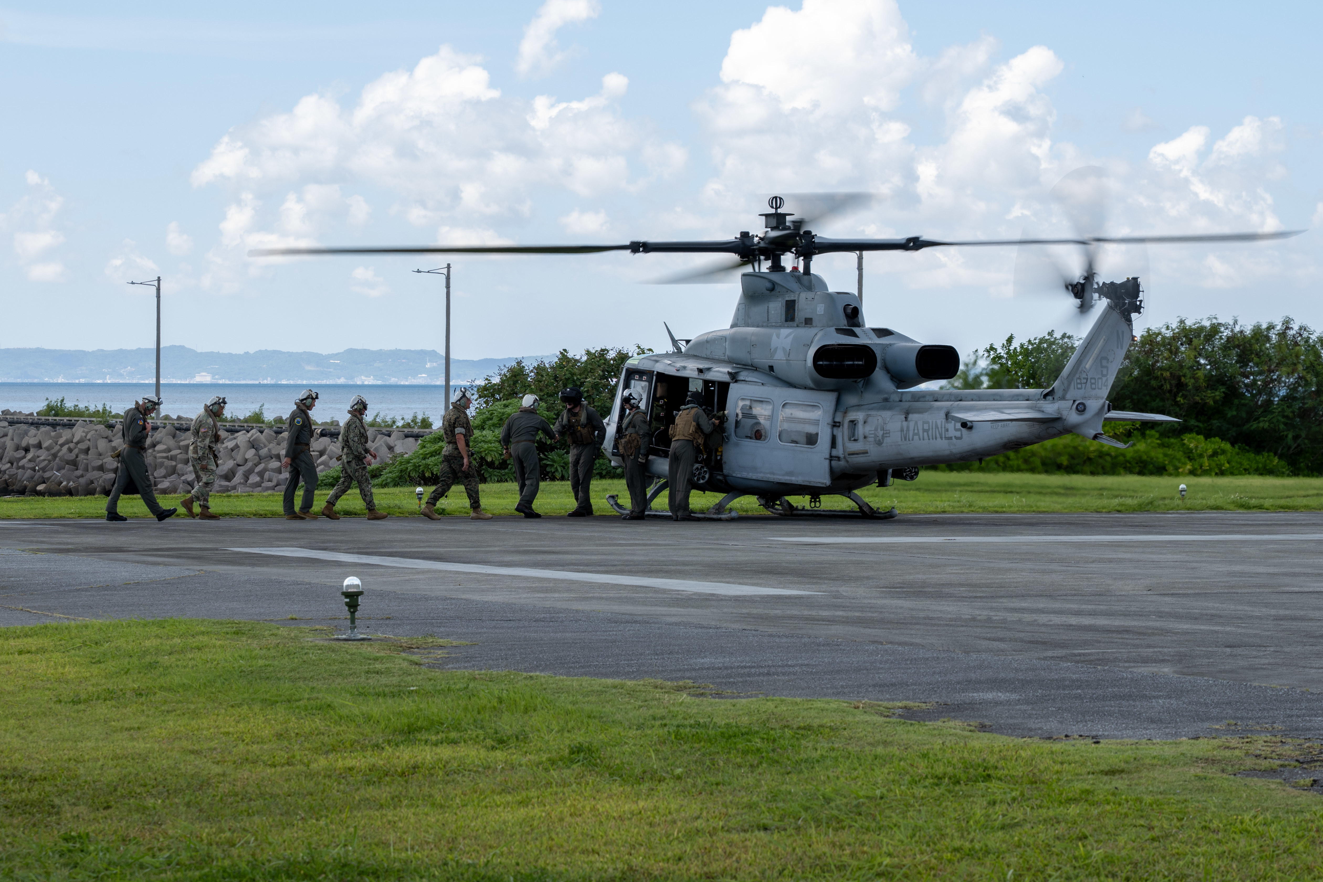 OKINAWA, Japan (Sept. 10, 2025) Adm. Steve Koehler, commander, U.S. Pacific Fleet; Lt. Gen. Roger Turner, commanding general of III Marine Expeditionary Force; Rear Adm. Tom Shultz, commander, Task Force (CTF) 76; Air Force Brig. Gen. John Gallemore, commander 18th Wing, Kadena Air Base, Japan; and members of their respective staffs board a Marine Corps UH-1Y Venom helicopter, attached to Marine Light Attack Helicopter Squadron 169, during Koehler’s visit to (CTF) 76 on White Beach Naval Facility, Okinawa, Sept. 10. Koehler’s visit to Okinawa underscored the Pacific Fleet’s commitment to integrated maritime operations alongside the U.S. Marine Corps and highlighted ongoing efforts to strengthen forward-deployed readiness, joint force interoperability, and regional partnerships in support of a free and open Indo-Pacific. Within the U.S. 7th Fleet area of operations, CTF 76 is responsible for conducting expeditionary warfare operations with Navy and Marine Corps capabilities to support theater contingencies that range from crisis response to full combat operations. (U.S. Navy photo by Mass Communication Specialist 2nd Class Danilo Reynoso)