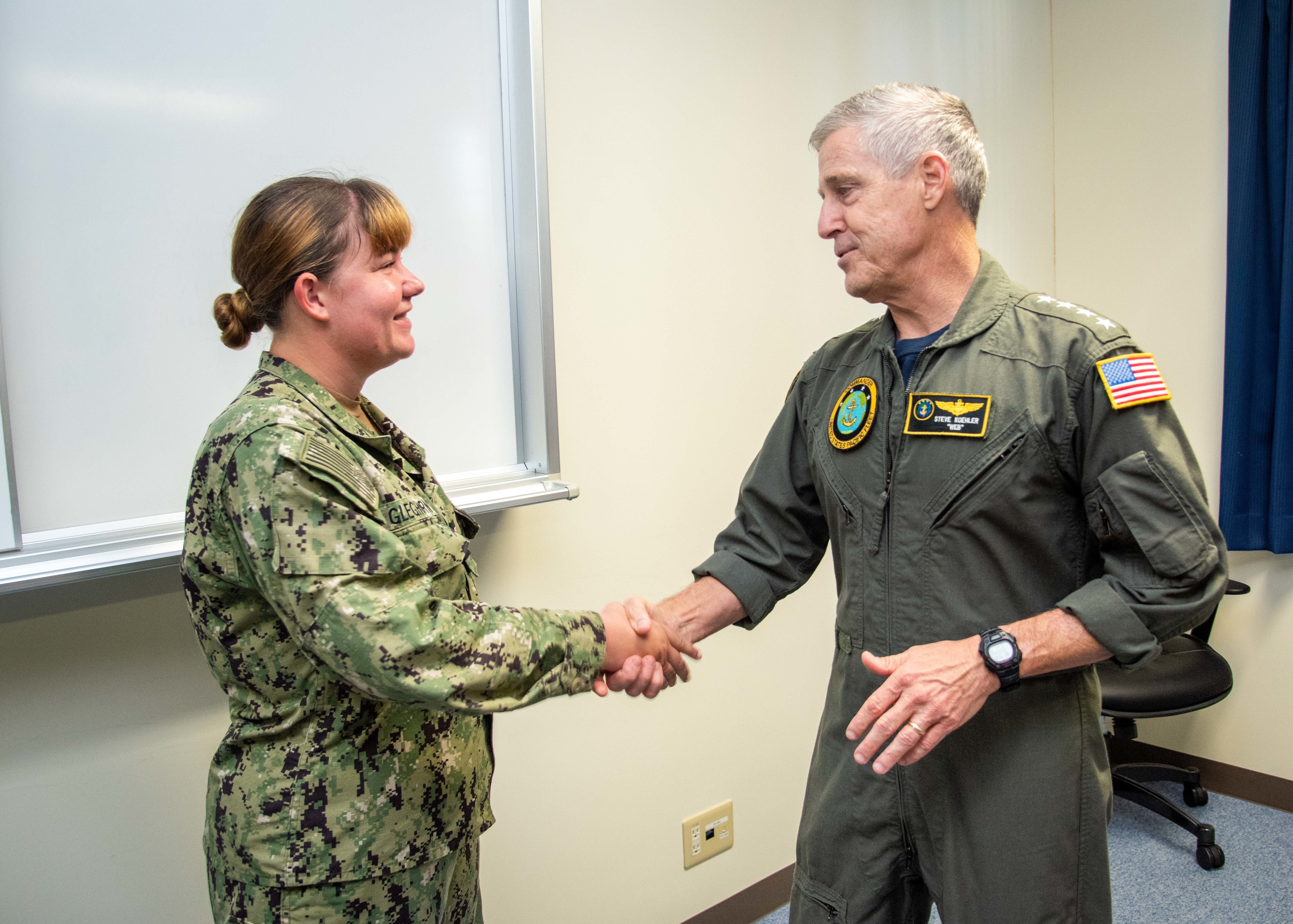OKINAWA, Japan (Sept. 10, 2025) Adm. Steve Koehler, commander, U.S. Pacific Fleet, presents a challenge coin to Information Systems Technician 2nd Class Emma Gleghorn during his visit to Commander, Task Force (CTF) 76 on White Beach Naval Facility, Okinawa, Sept. 10. Koehler’s visit to Okinawa underscored the Pacific Fleet’s commitment to integrated maritime operations alongside the U.S. Marine Corps and highlighted ongoing efforts to strengthen forward-deployed readiness, joint force interoperability, and regional partnerships in support of a free and open Indo-Pacific. Within the U.S. 7th Fleet area of operations, CTF 76 is responsible for conducting expeditionary warfare operations with Navy and Marine Corps capabilities to support theater contingencies that range from crisis response to full combat operations. (U.S. Navy photo by Mass Communication Specialist 1st Class Chase Stephens)