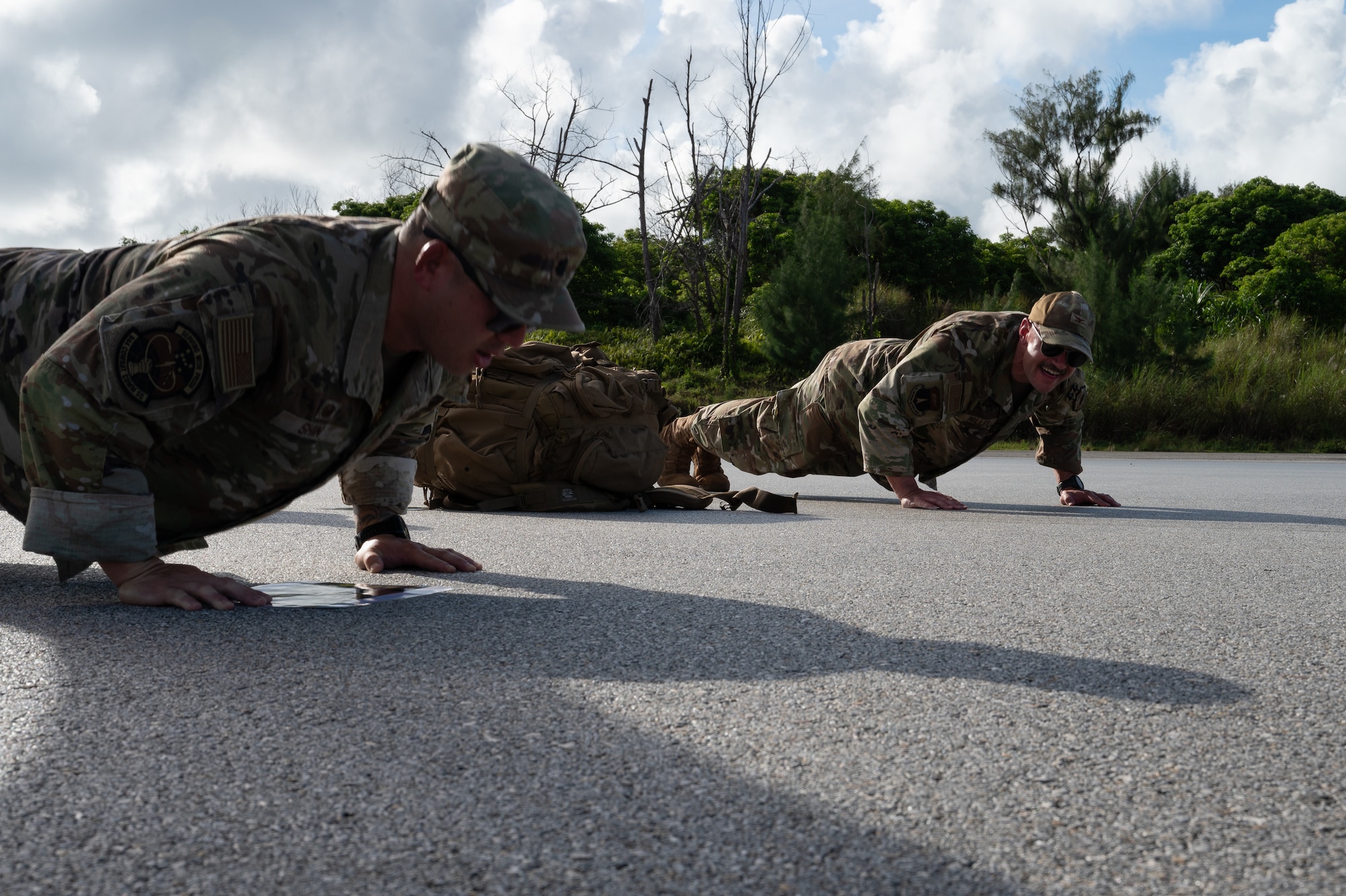 From left, U.S. Air Force Lt. Col. Alexander Shin, 644th Combat Controller Squadron commander, and Col. Andrew Miller, 36th Contingency Response Group commander perform memorial push-ups after a 9/11 Memorial Ruck at Andersen Air Force Base, Guam, Sept. 11, 2025.