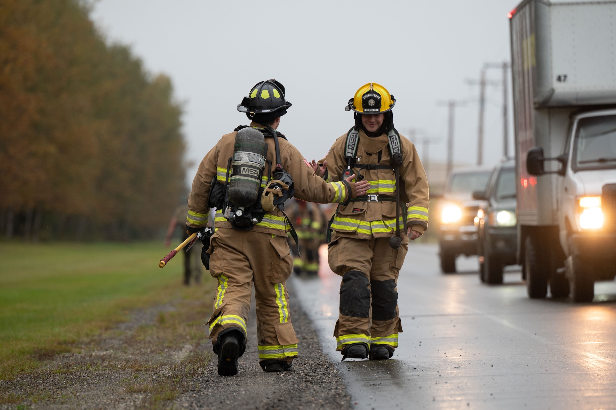 U.S. Senior Airman Hunter Miller and Airman 1st Class Jacob Burek, 354th Civil Engineer Squadron firefighters, high five during a two-mile ruck following the 24th annual 9/11 Remembrance Ceremony at Eielson Air Force Base, Alaska, Sept. 11, 2025.