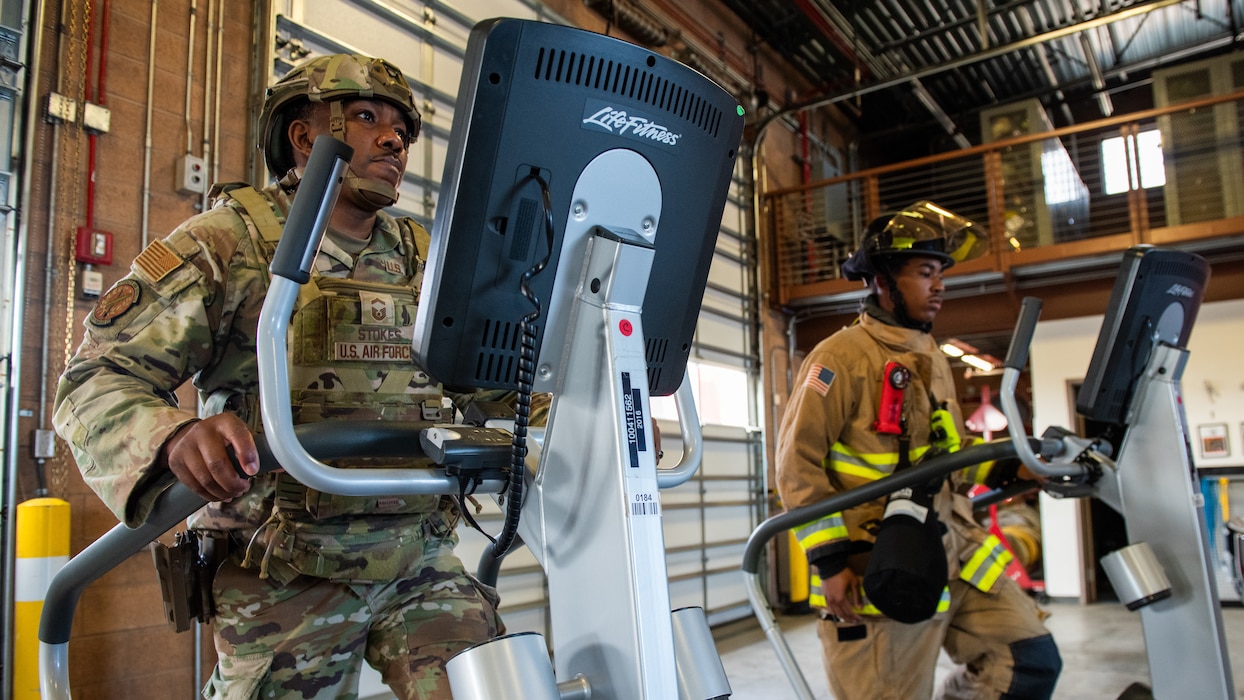 Airmen walking on stair machine
