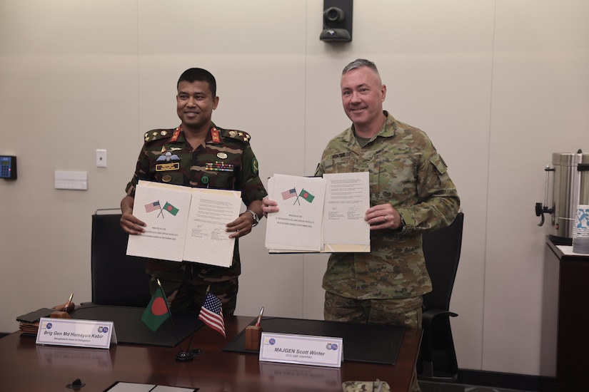 Maj. Gen. Scott A. Winter, U.S. Army Pacific Deputy Commander - Strategy and Plans, and Brig. Gen. Md Humayun Kabir, Director of the Military Training Directorate, displays the minutes from the Land Forces Talks at Fort Shafter, Hawaii, on Sept. 10, 2025.