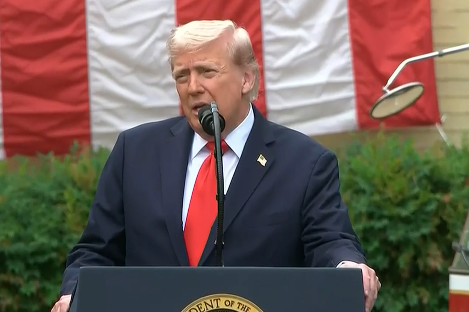 President Donald J. Trump speaks at a lectern.