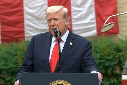 President Donald J. Trump speaks at a lectern.