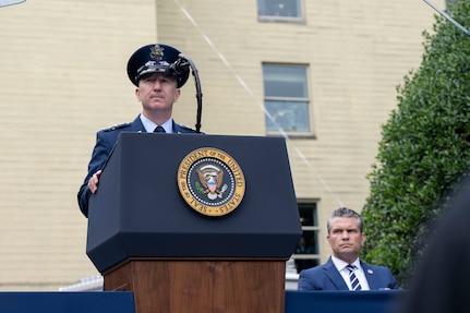 The chairman speaks at a podium.
