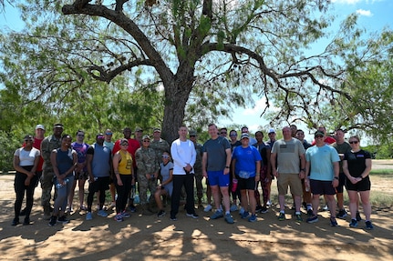 Members of the 960th Cyberspace Wing and 433rd Airlift Wing pose for a group photo Sept. 2, 2025, at Joint Base San Antonio-Lackland, Texas, after participating in a 5K run to kick off National Suicide Awareness and Prevention Month.