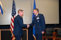 Col. Jeremy Patrick, 433rd Mission Support Group commander, shakes hands with Capt. Scott Bean, 433rd SFS commander, during an assumption of command ceremony at Joint Base San Antonio-Lackland, Texas, Sept. 6, 2025.