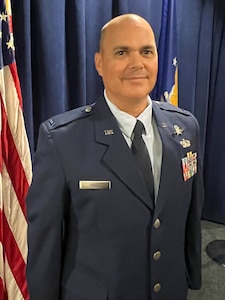 CWO2 Dell stands and smiles