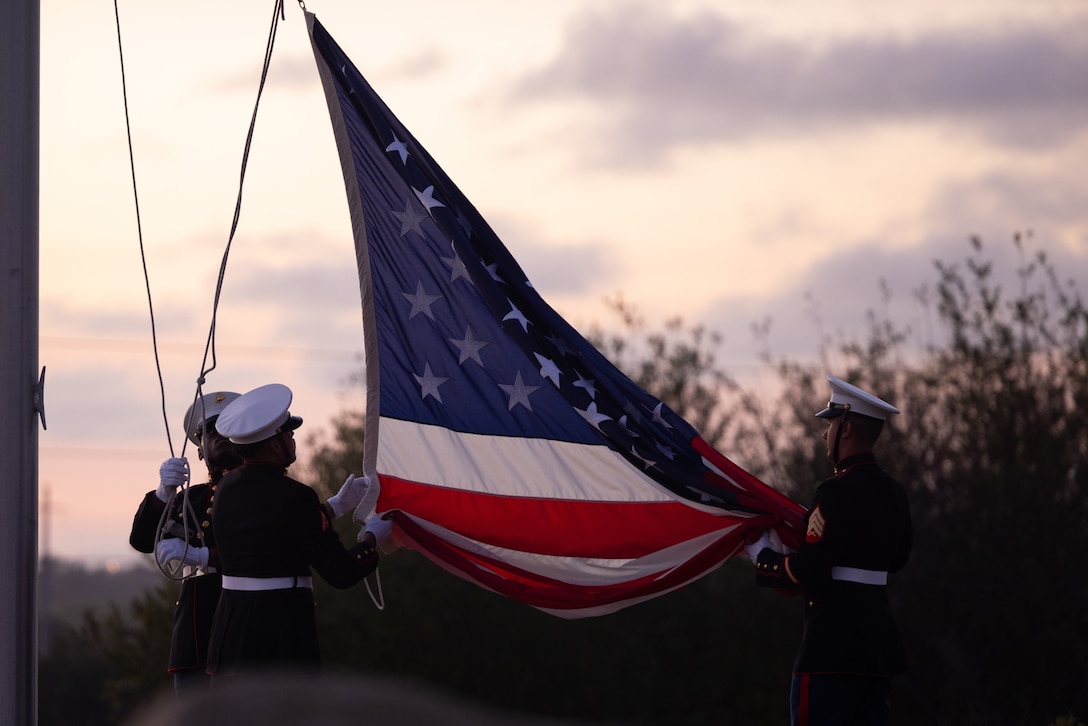 U.S. Marines with the color guard from Headquarters and Support Battalion, Marine Corps Installations West, lower the American flag during the 83rd Annual Evening Colors ceremony held at the Pacific Views Event Center, Marine Corps Base Camp Pendleton, California, on Sept. 11, 2025. The annual ceremony recognized the base’s history, legacy, and importance, commemorating the official establishment of MCB Camp Pendleton. Former President Franklin D. Roosevelt dedicated MCB Camp Pendleton to World War I Maj. Gen. Joseph H. Pendleton on Sept. 25, 1942, in honor of Pendleton's long advocacy for establishing a West Coast training base for the Marines. (U.S. Marine Corps photo by Cpl. Jeslianne Torres)