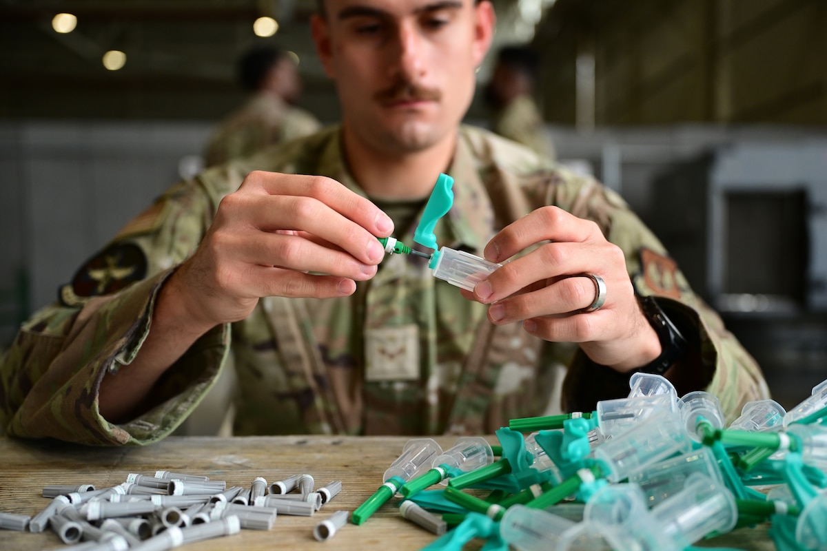 Airman holding syringe