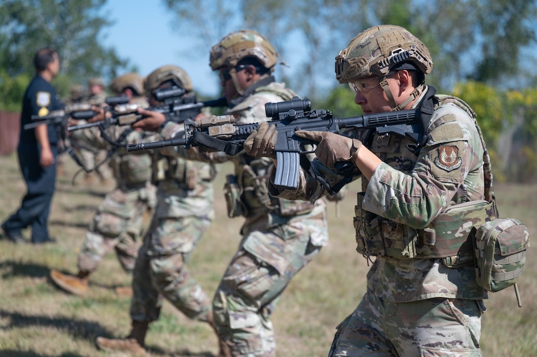 Airmen pointing rifles in formation