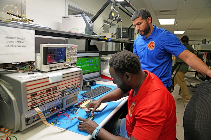 men working on electronics