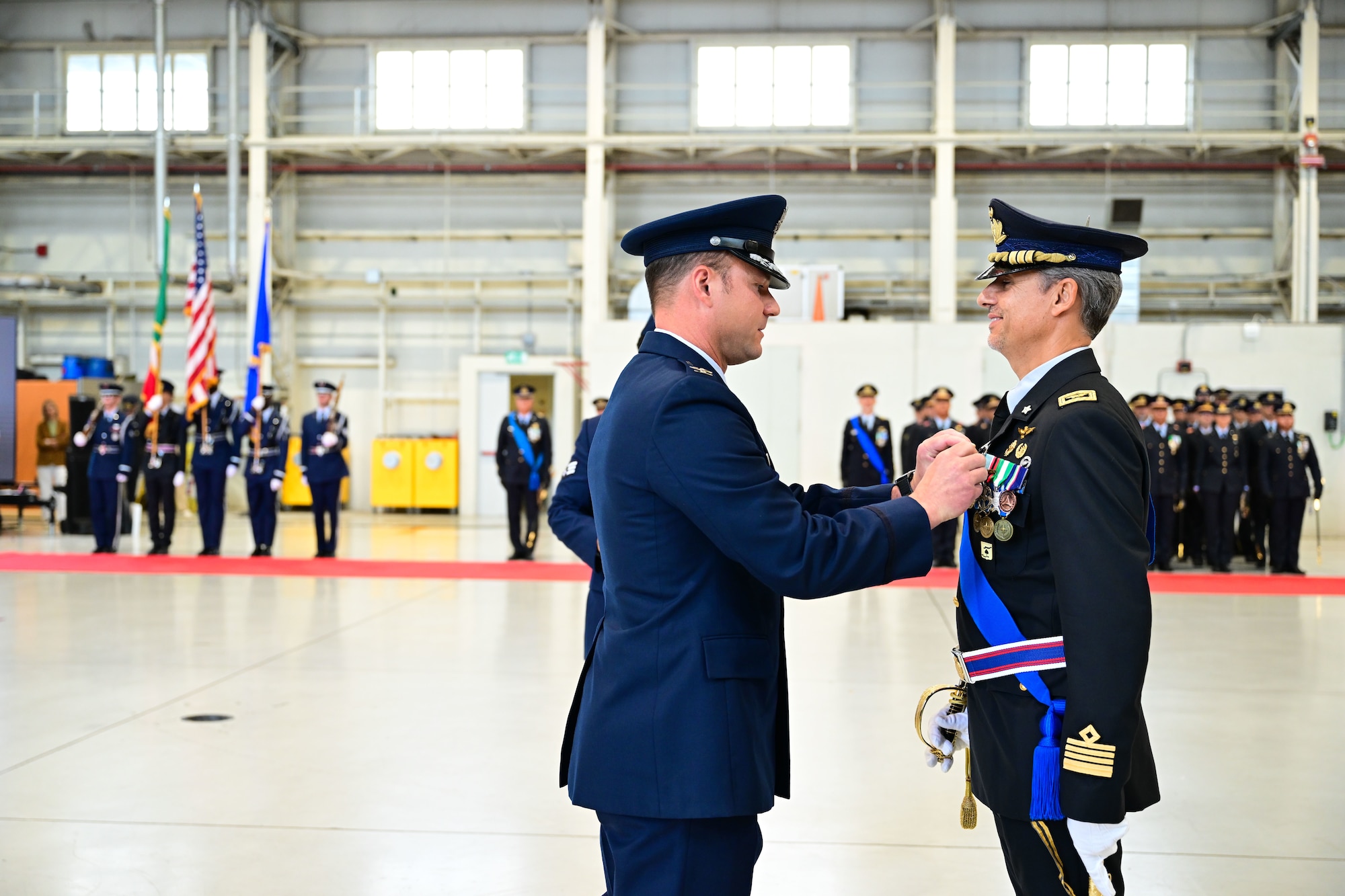 USAF colonel pins on a medal for the ITAF colonel.