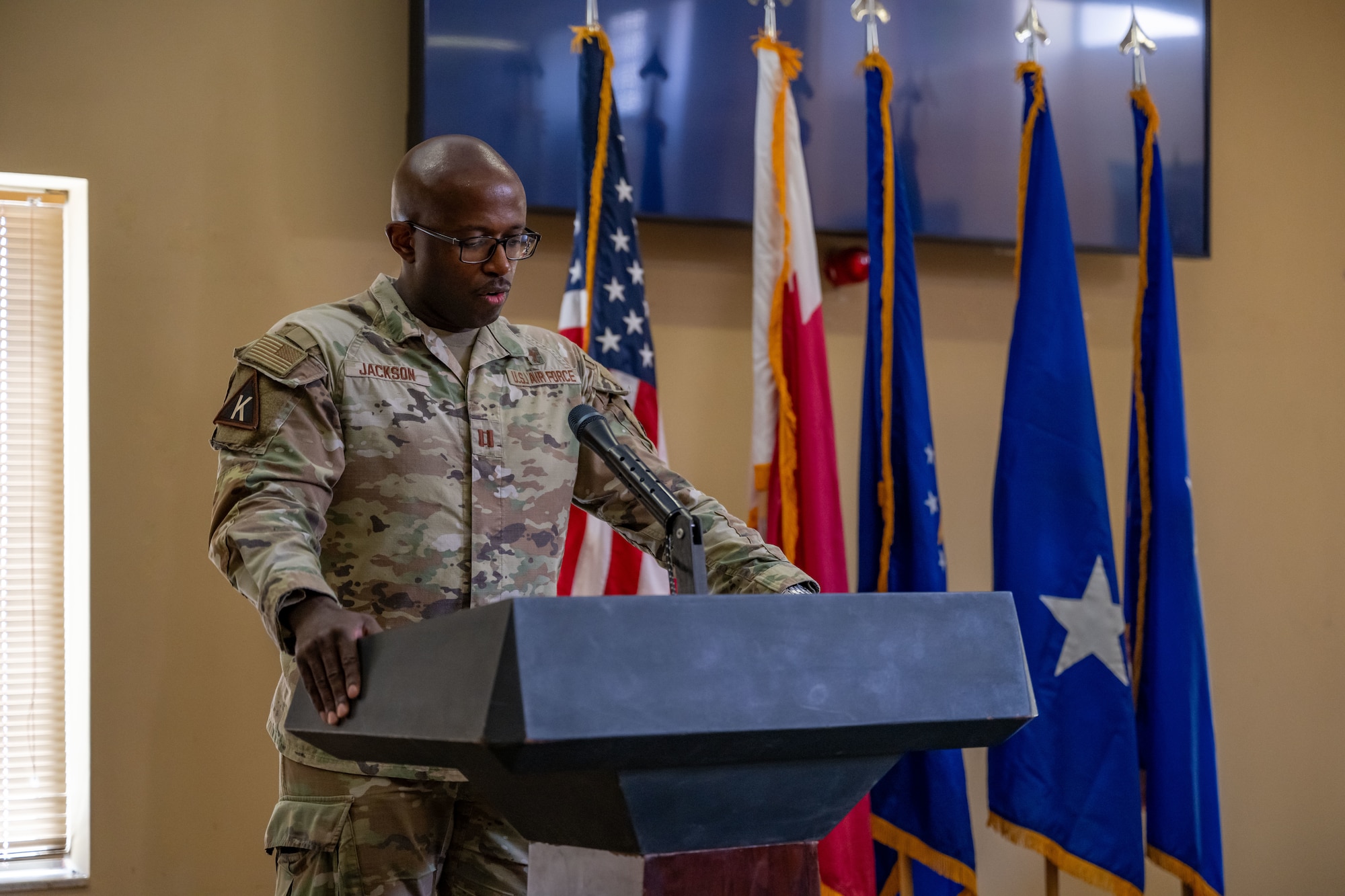 U.S. Air Force Chaplain Capt. Enrique Jackson, 379th Air Expeditionary Wing, gives an invocation during the 379th AEW Assumption of Command Ceremony within the U.S. Central Command area of responsibility, Sept. 12, 2025. The ceremony saw Brig. Gen. Daniel Clayton assume command of the largest wing in the AOR. (U.S. Air Force photo by Senior Airman Amanda Jett)