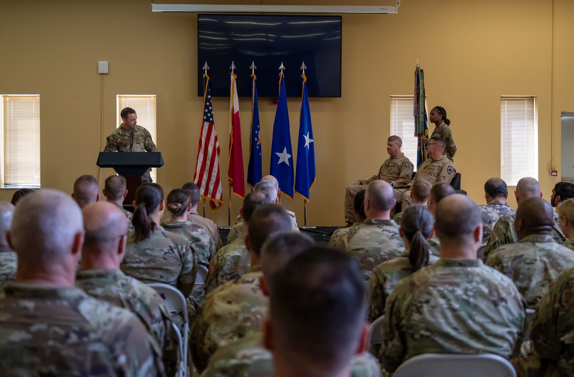 Members of the 379th Air Expeditionary Wing attend an assumption of command ceremony within the U.S. Central Command area of responsibility, Sept. 12, 2025. The assumption of command formally announces the new commanding officer and publicly recognizes their leadership over the unit. (U.S. Air Force photo by Senior Airman Amanda Jett)