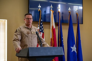 U.S. Air Force Brig. Gen. Daniel Clayton, 379th Air Expeditionary Wing incoming commander, gives a speech during the 379th AEW Assumption of Command Ceremony within the U.S. Central Command area of responsibility, Sept. 12, 2025. The assumption of command formally announces the new commanding officer and publicly recognizes their leadership over the unit. (U.S. Air Force photo by Senior Airman Amanda Jett)