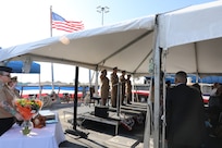 The official party salutes as the colors are presented during a change of command ceremony at Pier 6 on Naval Station Norfolk, Virginia, August 15, 2025.