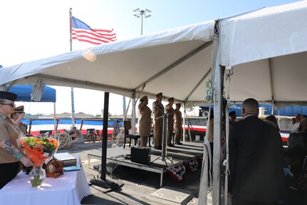 The official party salutes as the colors are presented during a change of command ceremony at Pier 6 on Naval Station Norfolk, Virginia, August 15, 2025.