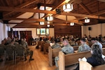 Wisconsin National Guard members, families and friends attend a dedicatory chapel service at the newly renovated Memorial Chapel on Camp Williams, near Camp Douglas, Wisconsin, Sept. 3, 2025. The service preceded the organization's first official change of stole ceremony during which U.S. Army Lt. Col. Jonathan Robertson replaced U.S. Army Col. Mark Brooks as the Wisconsin National Guard’s state chaplain. (U.S. National Guard photo by Isabella Jansen)