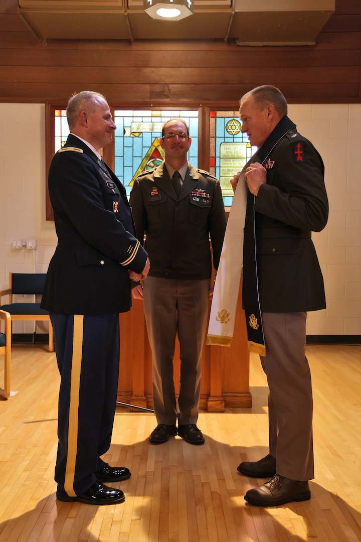 U.S. Army Maj. Gen. Matthew Strub, Wisconsin’s adjutant general, center, presides over the organization's first official change of stole ceremony at the newly renovated Memorial Chapel on Camp Williams, near Camp Douglas, Wisconsin, Sept. 3, 2025. The event symbolized the change of responsibility between outgoing state chaplain, U.S. Army Col. Mark Brooks, left, and incoming state chaplain, U.S. Army Lt. Col. Jonathan Robertson. (U.S. National Guard photo by Paul Gorman)