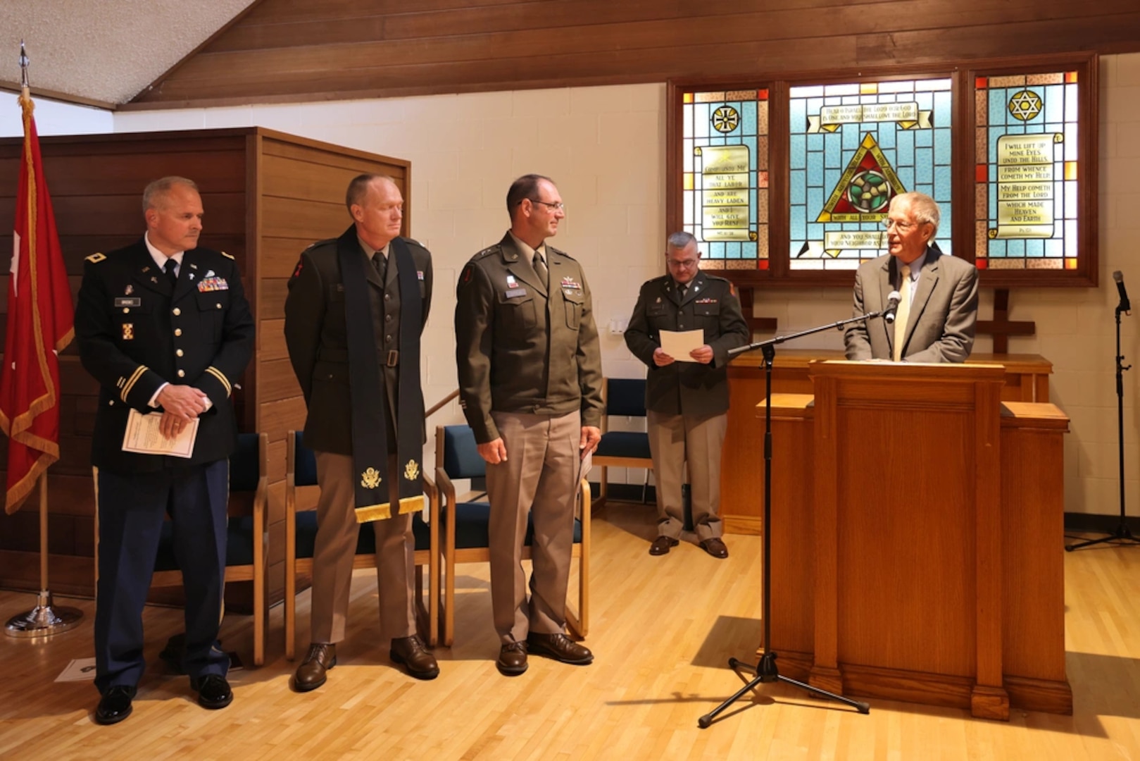 Pastor Garry Thompson, right, with the New Testament Association of Independent Baptist Churches, delivers the benediction following the Wisconsin National Guard's change of stole ceremony Aug. 3, 2025, in the Memorial Chapel on Camp Williams, near Camp Douglas, Wisconsin. The event symbolized the change of responsibility between outgoing state chaplain, U.S. Army Col. Mark Brooks, and incoming state chaplain, U.S. Army Lt. Col. Jonathan Robertson. (U.S. National Guard photo by Paul Gorman)